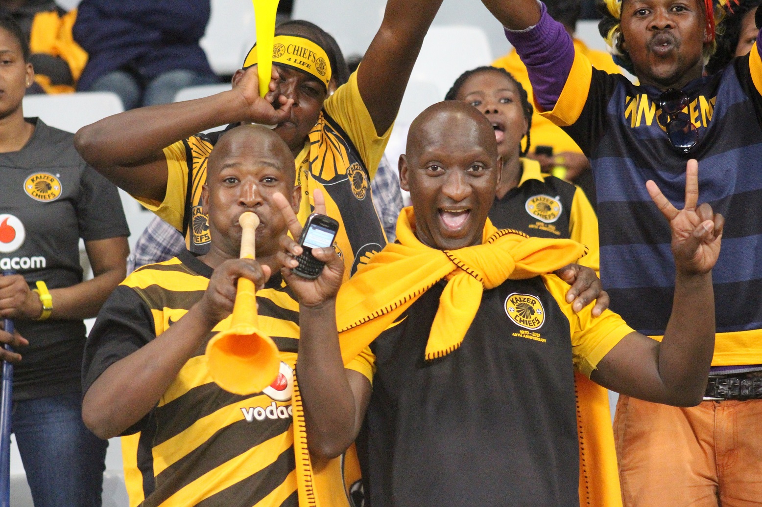 A fan of the Kaizer Chiefs symbolically changes his T-shirt